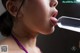 A woman sticking out her tongue with a bottle of water.