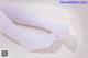 A pair of white stockings on a white surface.