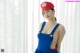 A woman in a blue dress and a red hat.